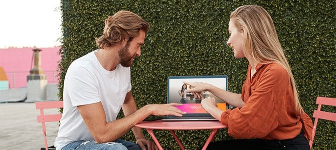 Gig Economy-01 two people sitting at a table looking at a laptop
